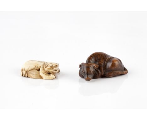 A Chinese ivory toggle late Ming carved as a reclining kylin, 4cm across, and a wood netsuke of a recumbent water buffalo, si