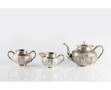 A Chinese three piece silver tea service circa 1900 decorated with bamboo handles, the centre of the bodies decorated with pa