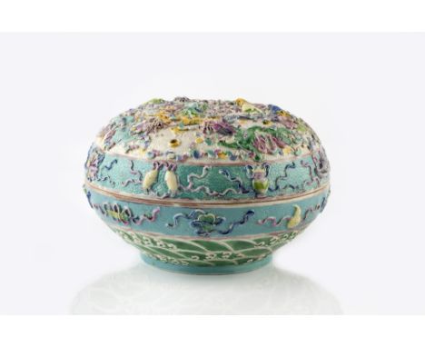 A Chinese porcelain covered bowl 19th Century with allover raised dragons on a white and turquoise ground with ribbons and tr