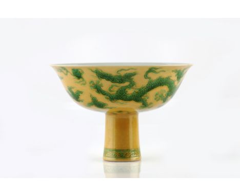 A Chinese porcelain stem cup 19th Century decorated five clawed dragons guarding a flaming pearl amidst clouds in green ename