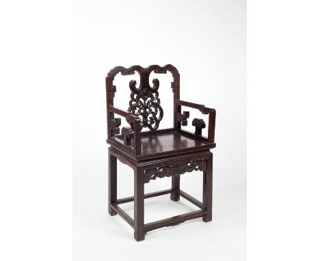 A Chinese black wood altar chair 19th Century  with carved panel back and open arms, 99cm high