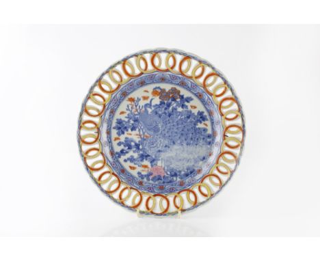 A Japanese Arita charger 19th Century the central blue panel with phoenix and having an interlace border, 34cm