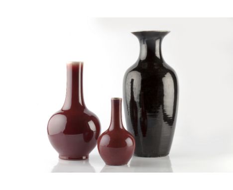 A Chinese black ground vase 19th Century of baluster form 45cm and two Chinese sang de boeuf vases, 33cm and 22cm