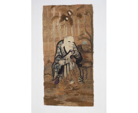 A Japanese embroidered panel of gold embroidery depicting a wise man with a tiger, 121cm long