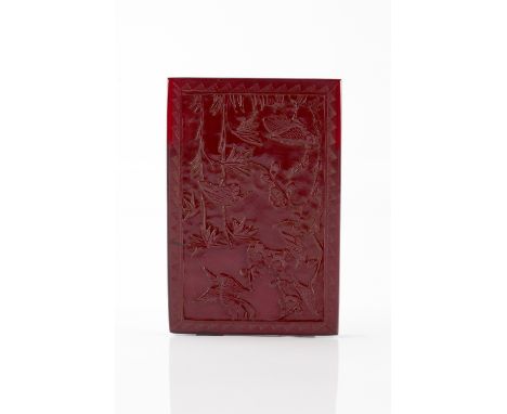 A Chinese amber panel 19th Century carved with a crane, other birds and blossom within a chevron border