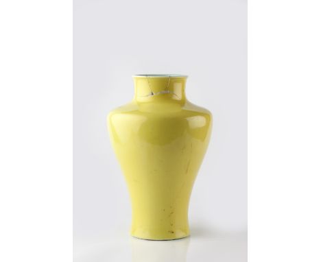 A Chinese porcelain vase of inverted baluster form 19th Century decorated allover with an Imperial yellow glaze, foot with re