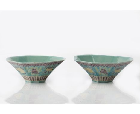 A pair of Chinese octagonal porcelain bowls 19th Century decorated with eight Buddhist symbols in yellow, green and aubergine