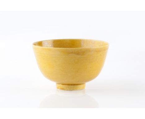 A Chinese porcelain mustard yellow glazed bowl Qianlong of high sided rounded form, foot with six character Zhuanshu seal Qia