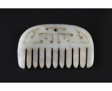 A Chinese Western Han style white jade pendant probably Ming 17th Century modelled as an eleven toothed comb, the back carved