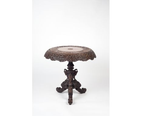 A hardwood carved Burmese tripod table 19th century  the top decorated with central carved bird motif surrounded by foliate a