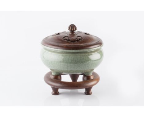 A Chinese crackled celadon glazed tripod censer late 19th Century on fitted wood stand and wood cover with pierced ruyi head 
