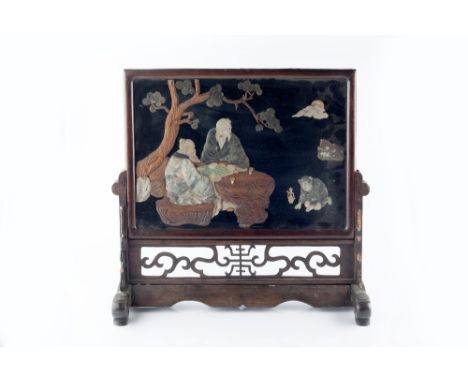 A Chinese soapstone table screen 19th Century two scholars playing Go under a pine tree, in a hardwood frame, approximately 5