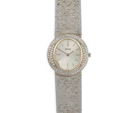 18ct white gold case, manual wind movement, late 1970s, signed oval silvered dial with applied baton hour markers, diamond-se
