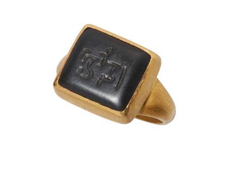 collet set with a polished oval onyx intaglio with Arabic script, to a plain satin finish shankRing size: L/M
