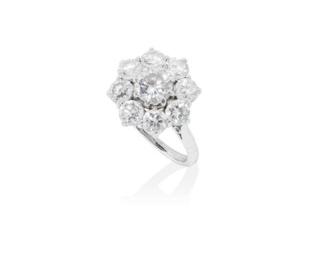 claw set with a round brilliant-cut diamond, in a border of eight smaller round brilliant-cut diamonds, shank stamped 18CT PL