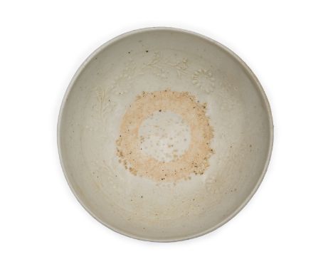 A Chinese provincial qingbai-glazed moulded bowlYuan dynastyThe interior with moulded floral scroll encircling an unglazed ri