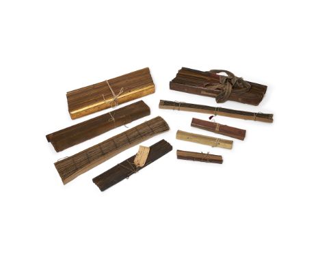 Nine palm leaf manuscripts19th - early 20th centuryComprising: a Tamil manuscripts bounded between wood boards, 39.5cm long; 