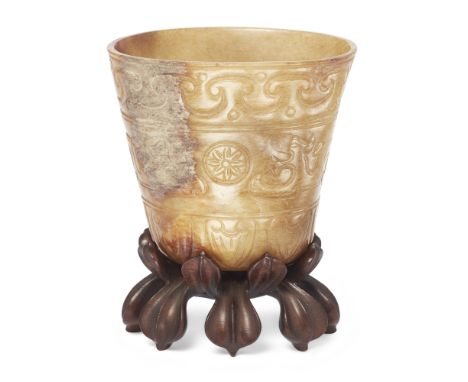 A Chinese mottled creamy and mushroom jade archaistic cupMing dynasty The tapering shape thinly carved and incised to the ext