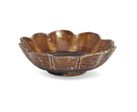 A Chinese Henan brown-glazed foliate dishSong-Liao dynasty, 11th/12th centuryThe shallow flower-shaped vessel potted with ten