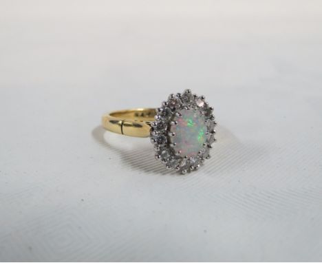 18CT GOLD OPAL &amp; DIAMOND CLUSTER RING WITH 1.25 CARAT OPAL AND CIRCA 0.20 CARATS OF DIAMONDS