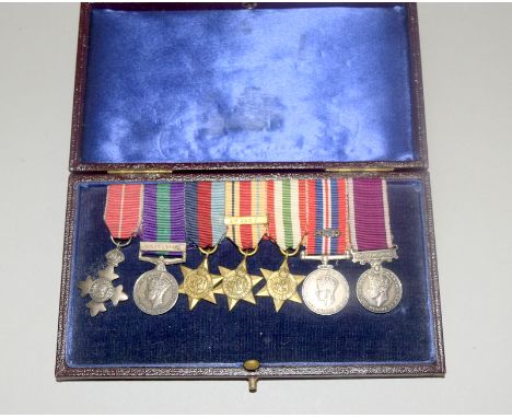 A cased set of WW2 mounted dress miniature medals to an unknown recipient, the medals are the OBE, GSM with Palestine clasp, 