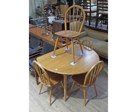 An Ercol light elm and beech drop leaf table and four chairs, height 72cm, width 113cm.  Some light wear to the finish