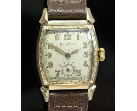 A 1940s Bulova Watch Co Art Deco style gold plated manual wind wristwatch with signed champagne dial, gold Arabic numerals an