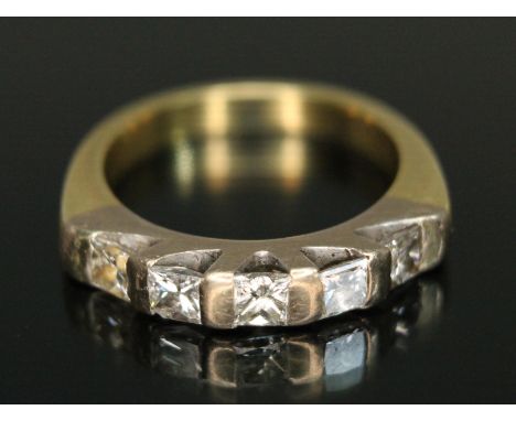 A five stone diamond ring, the princess cut stones weighing approx. 0.20 carats each, band marked '750', gross wt. 6.77g, siz
