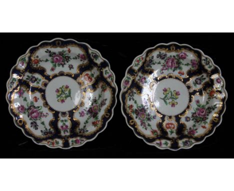 A pair of Worcester porcelain plates, circa 1770, of scalloped formed and decorated with floral bouquets within gilt borders 