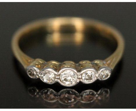 An early 20th century five stone diamond ring, the bezel set diamonds weighing approx. 0.21 carats, band marked '18ct', gross