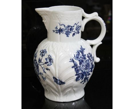 A large Worcester porcelain jug, circa 1765, cabbage leaf moulded with bearded mask spout and shaped handle, decorated in blu