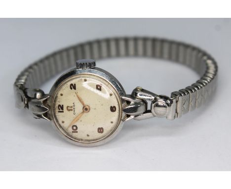 A 1947 stainless steel Omega ladies wristwatch 2548-4, having signed champagne dial, Arabic numerals and leaf hands, signed a
