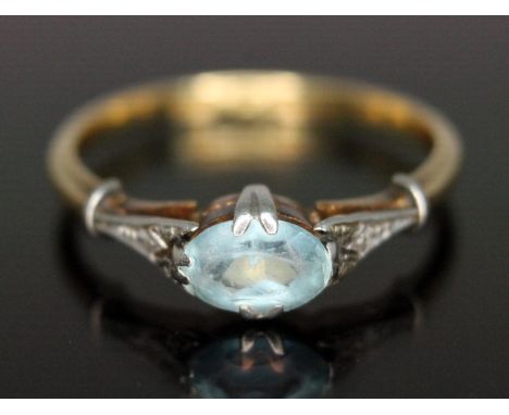 An early 20th century aquamarine ring, the oval cut stone weighing approx. 0.78 carats, band marked '18ct PLAT', gross wt. 3g