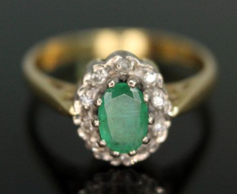 An emerald and diamond cluster ring, the cluster measuring approx. 9.65mm x 8.05mm, hallmarked 18ct gold, gross wt. 2.85, siz