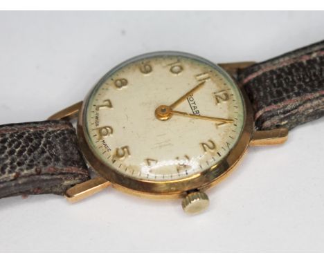 A 1950s hallmarked 9ct gold Rotary 15 jewel manual wind ladies wristwatch with Arabic numerals and hands in gold on a champag
