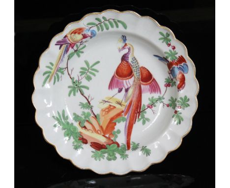 A Worcester porcelain plate, circa 1770, of scalloped form and decorated in the workshop of James Giles with exotic birds, di