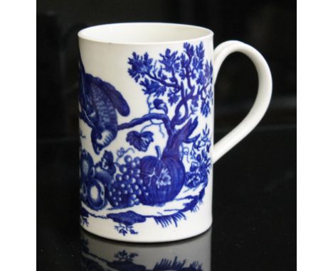 A Worcester porcelain mug, circa 1760 decorated with blue transfer depicting a bird above various fruits, height 11.5cm.  Con