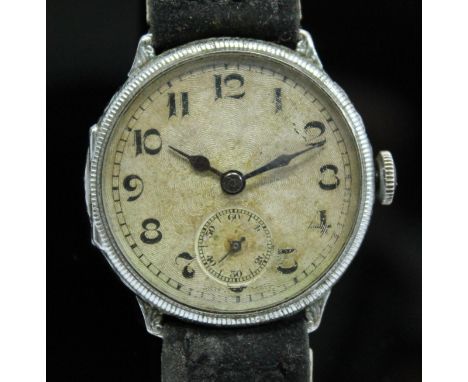 A 1920s silver cased wristwatch having unsigned guilloche dial with Arabic numerals and seconds subsidiary dial at 6 o'clock,