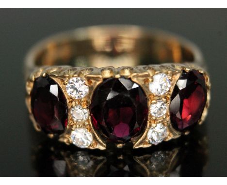 A hallmarked 9ct gold garnet and colourless stone ring, gross wt. 5.27g, size R.  