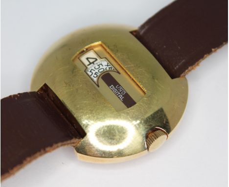 A vintage gold plated Uno Digital jump hour wristwatch with 17 jewel manual wind movement, 35mm bubble shaped case with stain