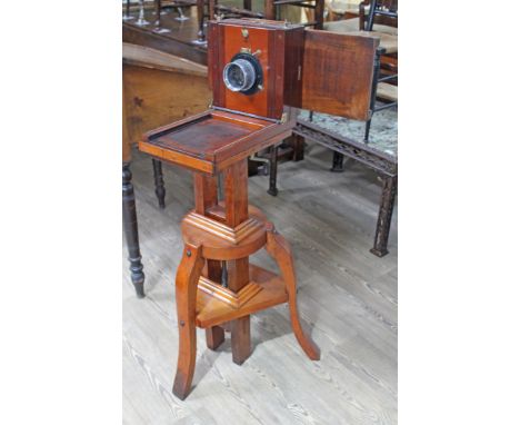 A Victorian mahogany studio plate camera with Dallmeyer lens and on adjustable tripod base.  