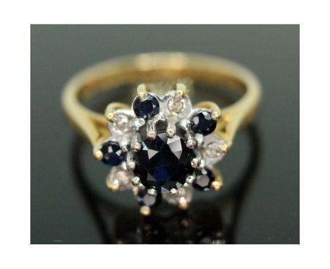 A sapphire and diamond cluster ring, the cluster diameter approx. 11mm, hallmarked 18ct gold band, gross weight 3.54g, size K