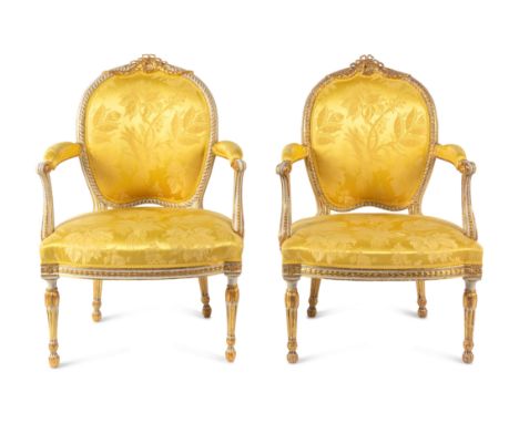 A Matched Pair of George III White-Painted and Parcel-Gilt ArmchairsOne Attributed to Thomas Chippendale, Circa 1775; The Oth