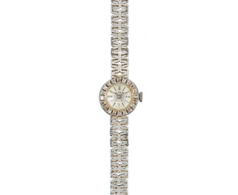 An 18ct white gold and diamond set lady's manual wind cocktail wristwatch. The 12mm silvered dial signed ROVER, 17 jewel Swis