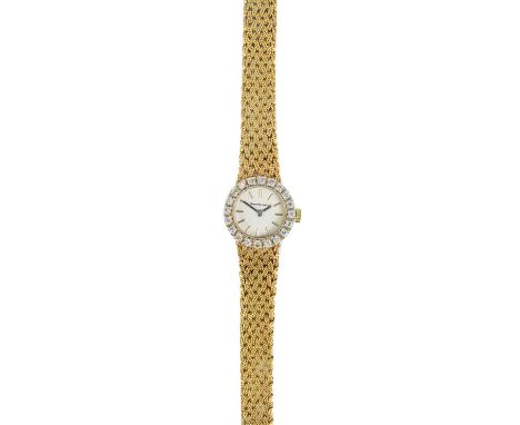 A Bueche-Girod 9ct gold lady's manual wind bracelet wristwatch with diamond-set bezel. With 14mm signed silvered dial, signed