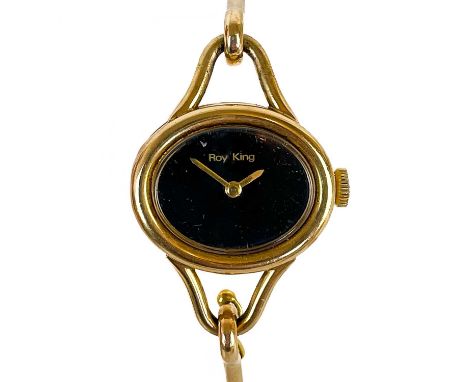 A 1970's 9ct gold bangle lady's manual wind wristwatch by Roy King. The 20mm oval black dial signed in gilt, with 17 jewel Sw