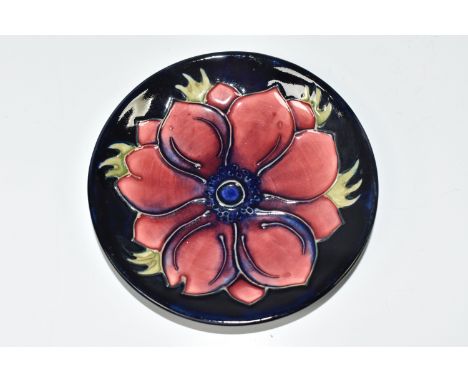 A MOORCROFT POTTERY 'ANEMONE' TRINKET DISH, tube lined with a pink-purple anemone flower on a navy blue ground, painted and i