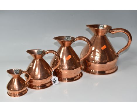 A GROUP OF FOUR NINETEENTH CENTURY COPPER GRADUATING MEASURING JUGS comprising measures in half gallon, one quart, one pint, 
