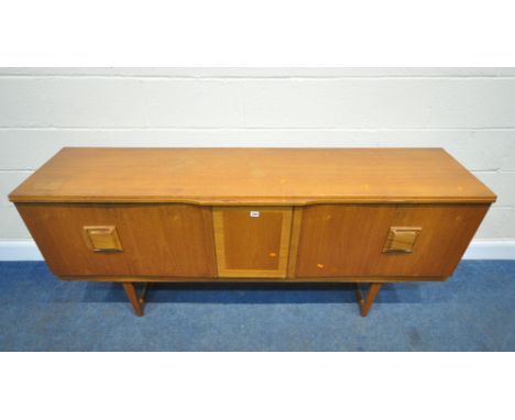 A MID CENTURY TEAK SIDEBOARD, fitted with two bi-fold doors, flanking a central door, with articulated drinks cabinet, length