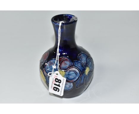 A MOORCROFT POTTERY 'CLEMATIS' VASE, of bulbous form with an elongated neck, tube lined with purple and blue clematis flowers